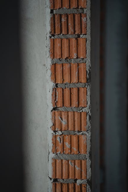 Detailed view of a brick and cement wall section, showing texture and workmanship.